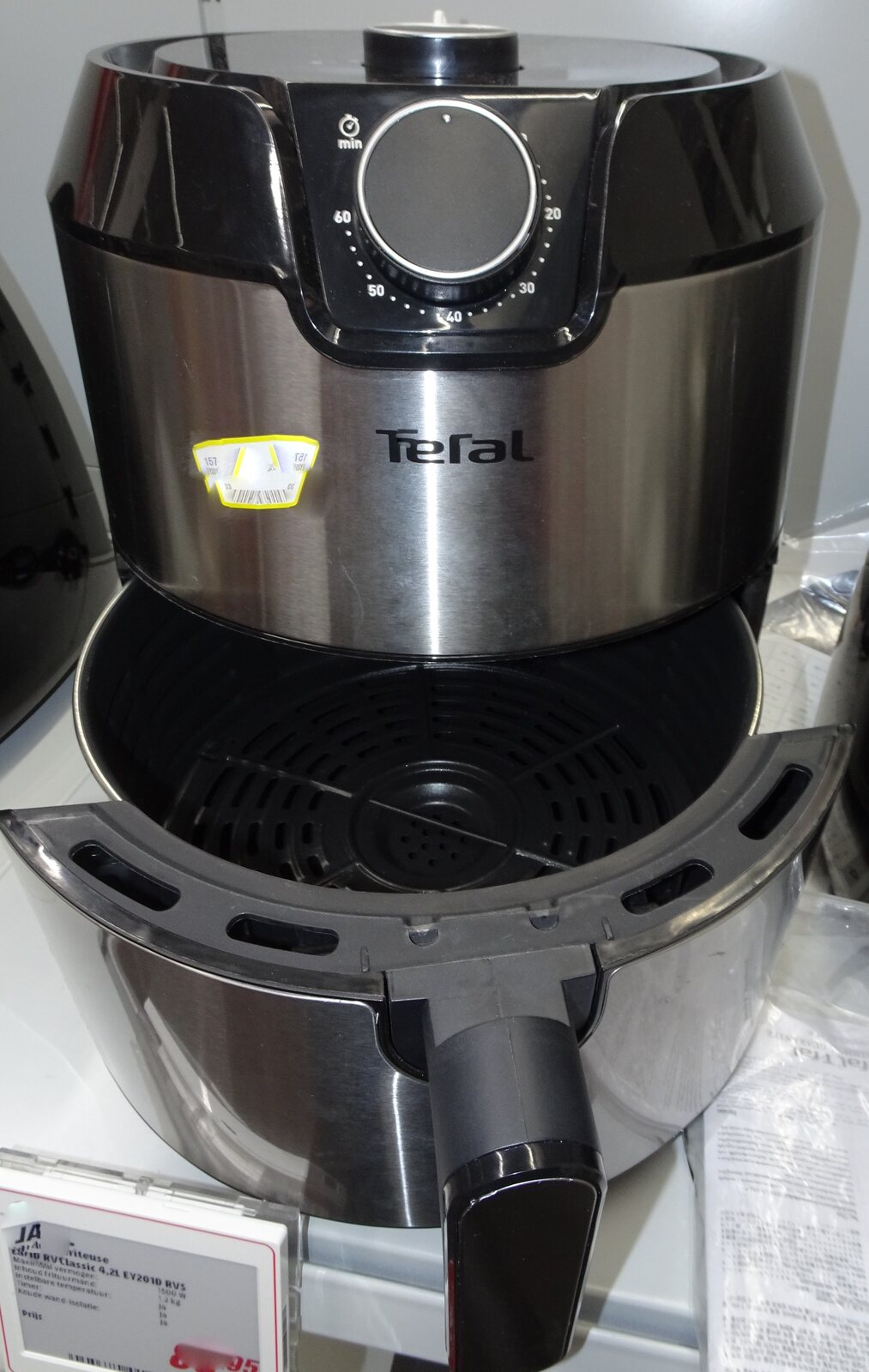 A real countertop air fryer with its cooking basket open