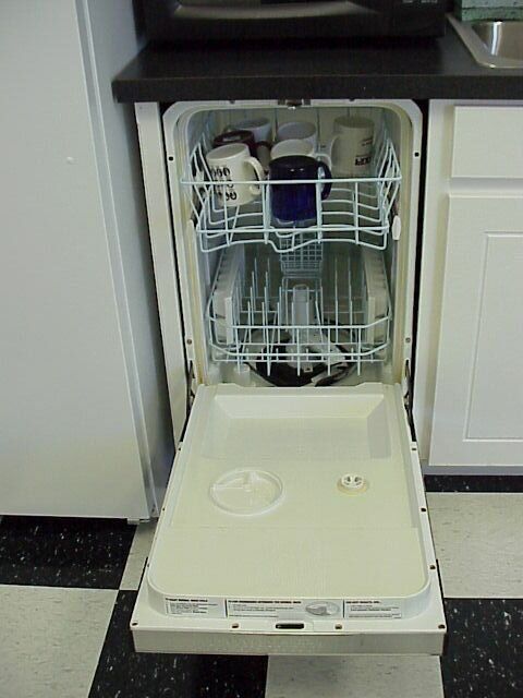 A real built-in dishwasher standing open with its racks visible