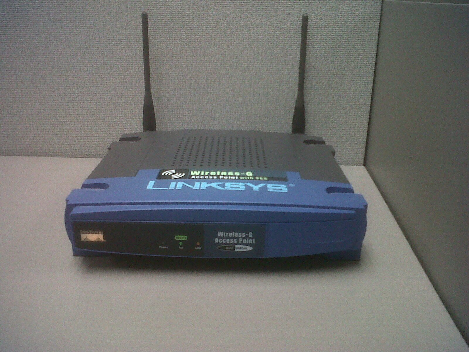 A real wireless access point with an antenna and Ethernet cable
