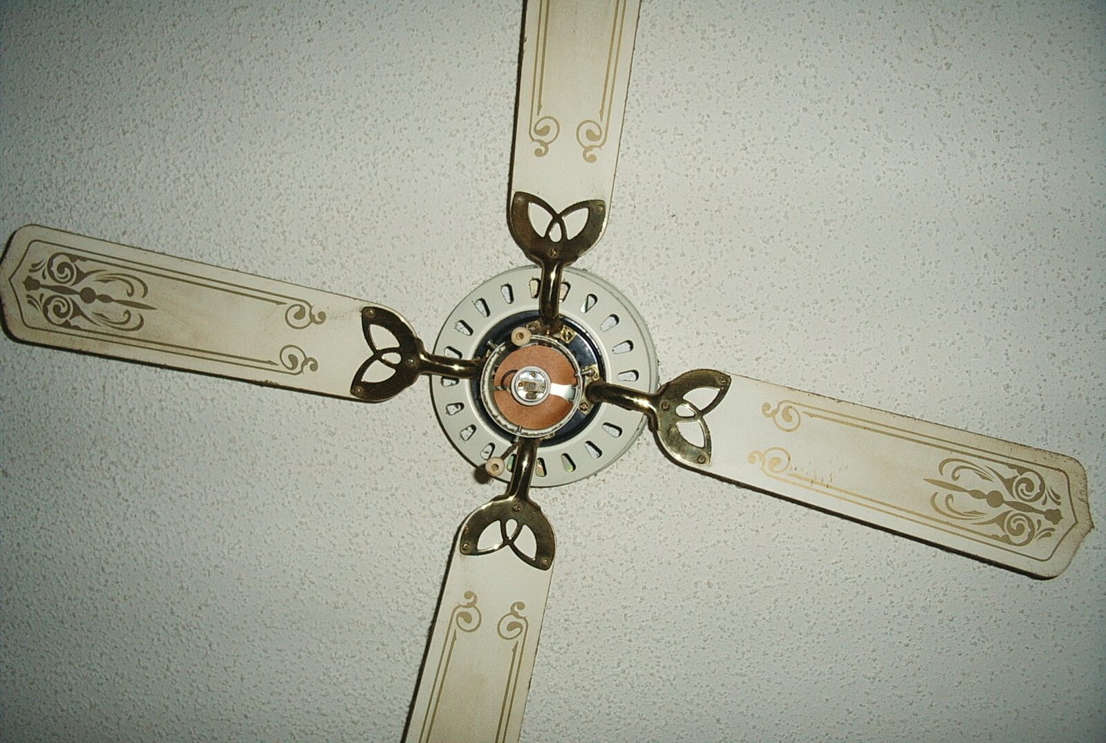 A four-blade ceiling fan viewed from below