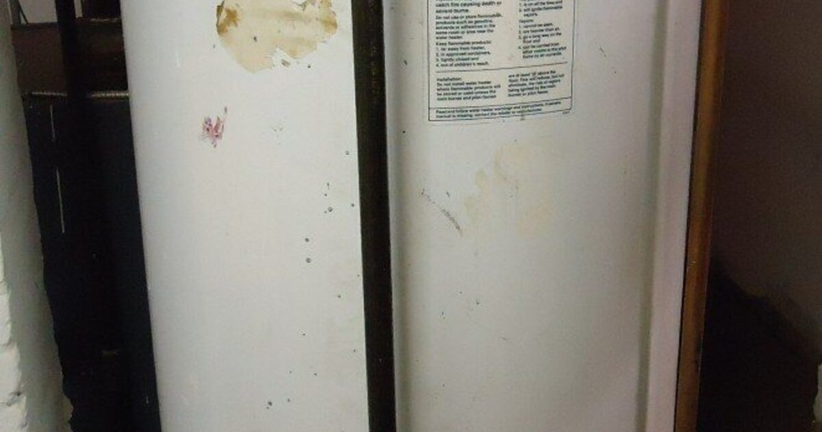 A real gas storage water heater with visible connected piping