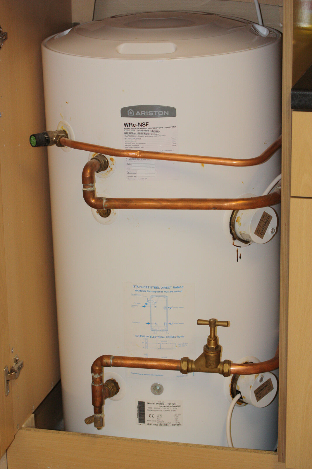 A real electric hot-water storage tank installed in a utility space