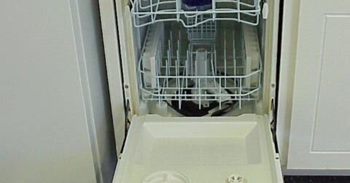 A real built-in dishwasher standing open with its racks visible
