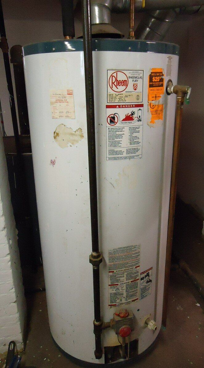 A real gas storage water heater with visible connected piping